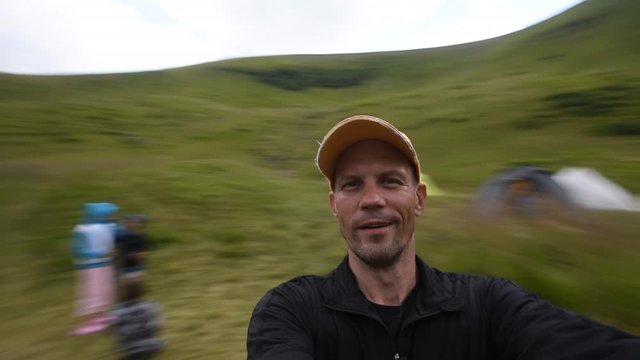Happy active man making panoramic selfie during walk in Carpathians