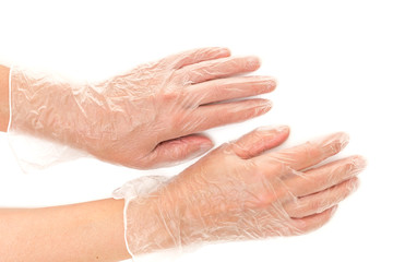 Disposable vinyl gloves on hands close up isolated on white background