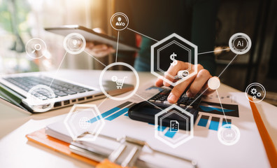 Businesswoman hand working digital marketing media in virtual screen with mobile phone and modern compute with VR icon diagram at office in morning light 
