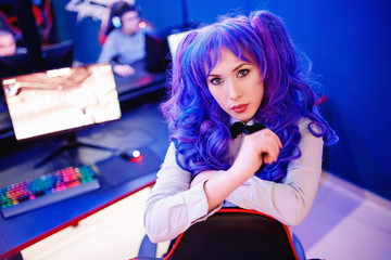 Young woman professional gamer playing winning tournaments online games computer