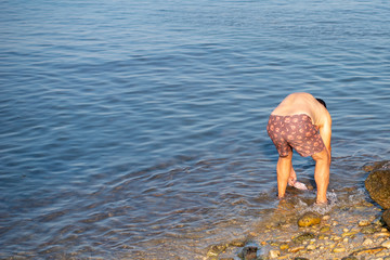 Fisherman cleaning fresh catch at the sea.