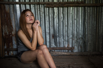 Fototapeta na wymiar homeless unemployed woman in ruin house