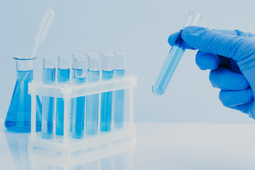 scientific laboratory equipment. hands of a scientific researcher in blue gloves
