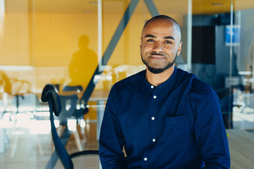 Happy african american businessman entrepreneur startup owner stand in modern office looking at...
