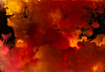 Paint spilled into the water. Mixing color paints