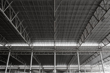 Metal frame of the factory roof in construction.