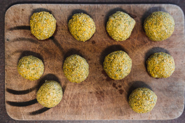 plant-based food, vegan homemade chickpea falafel balls on cutting board ready to be fried