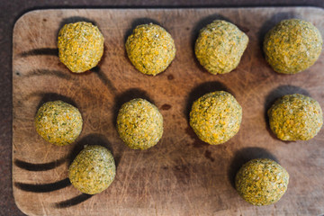 plant-based food, vegan homemade chickpea falafel balls on cutting board ready to be fried