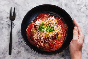 plant-based food, vegan homemade chickpea falafels dipped in tomato sauce with dairy-free cheese topping