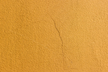 the texture of the concrete is yellow, covered with cracks. Suitable for advertising and can be used as a background.