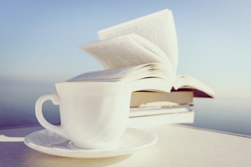 Coffee cup and books outdoors