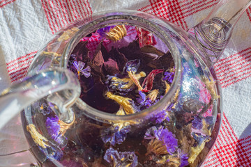 Close-up of a glass teapot with brewed flower tea inside