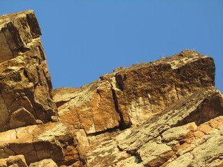 Mountain landscape. Peak. Rock on a background of blue sky. Low angle view. Close-up. Krasnoyarsk. National Nature Reserve 