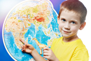 Little boy with toy giraffe and world map