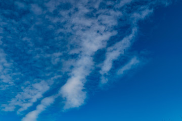 simple blue sky with white clouds in the cool season, freshness and a clear Sunny day in nature
