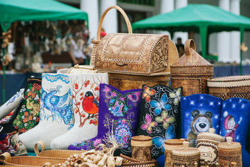 2012 June - Suzdal, Russia - traditional russian souvenirs on a street counter - valenki, shawls,...