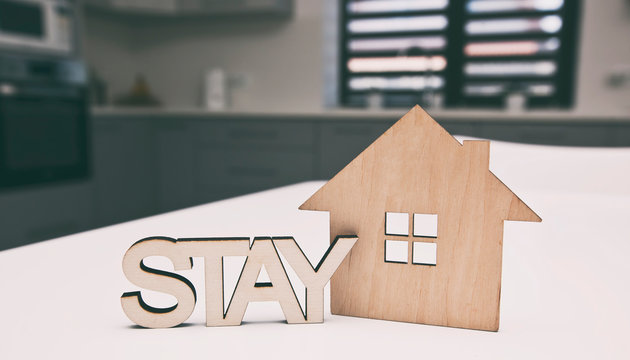 The wooden little house and word "stay" near it. Stay home to stop spreading the virus reduce risk of infection. Protect world from Coronavirus - Powered by Adobe