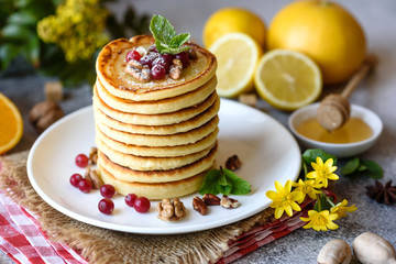 Delicious fresh beautiful pancakes with citrus honey and jam