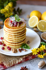 Delicious fresh beautiful pancakes with citrus honey and jam