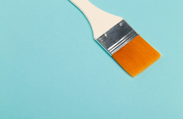 Paint brush isolated on blue background with copyspace.