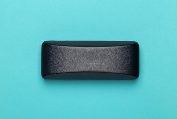 Black box of glasses or sunglasses isolated on blue background.