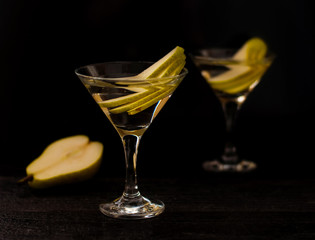 alcohol coctail glass on a black background. cocktail with pears. horizontal banner for designers