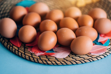 Closeup view from above lots of eggs on a blue pastel background with copy space