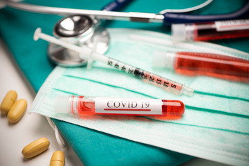 Coronavirus negative blood test tube sample of patient in laboratory over table on mask