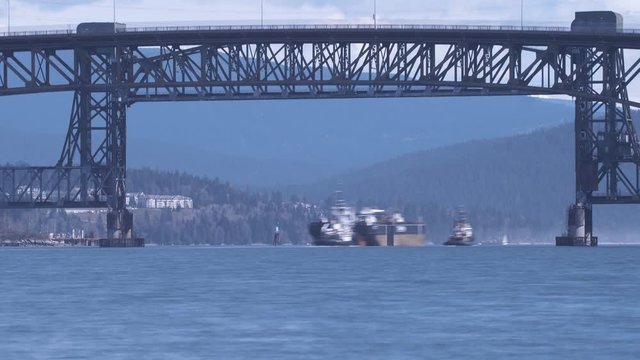 Time lapse of cargo ships and tugboats passing under the Second Narrows Rail Bridge. The Second Narrows Rail Bridge is a vertical-lift railway bridge that crosses the Burrard Inlet and connects Vancou
