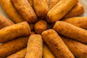 view of potato croquettes with parsley, garlic, egg and cheese on a white plate. Vegetarian food