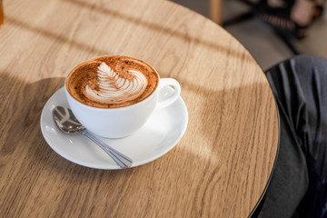 Coffee latte art on wooden table