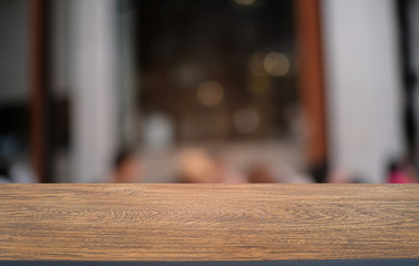Empty dark wooden table in front of abstract blurred bokeh background of restaurant . can be used for display or montage your products.Mock up for space.