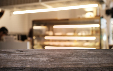 Empty dark wooden table in front of abstract blurred bokeh background of restaurant . can be used for display or montage your products.Mock up for space.