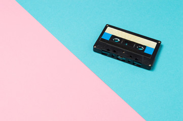 Retro audio cassette tapes on colorful background. Vintage music technology concept.