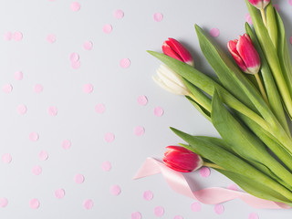 Tulips flat lay with pink and white flowrs on blue background