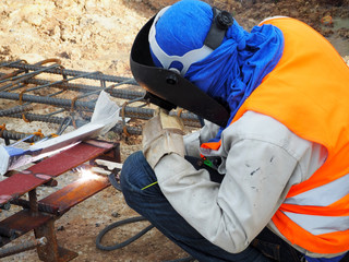 Welding work ,worker with protective welding metal on construction