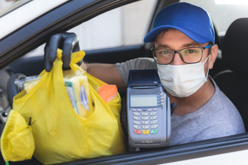 Fototapeta na wymiar Delivery guy with protective mask and gloves delovering groceries during lockdown and pandemic.