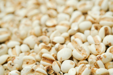 millet in a wooden bowl isolated on white