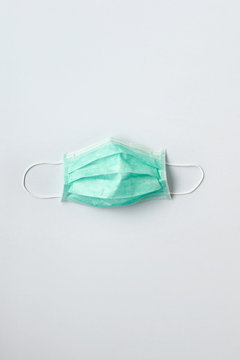 Still life of a green face mask on white background