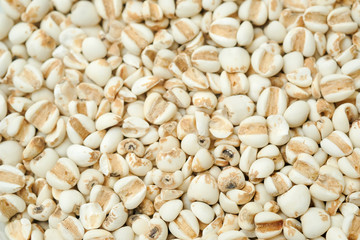 millet in a wooden bowl isolated on white