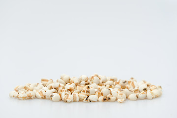 millet in a wooden bowl isolated on white
