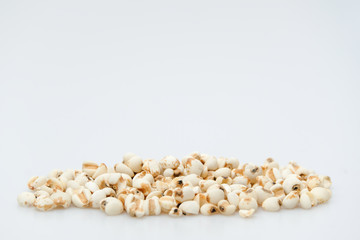 millet in a wooden bowl isolated on white