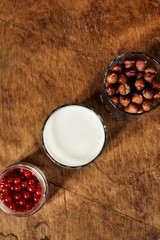 Yogurt with nuts on a wooden light background. View from above. Natural yogurt.