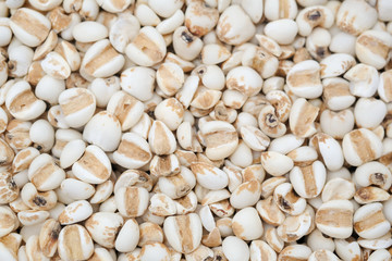 millet in a wooden bowl isolated on white