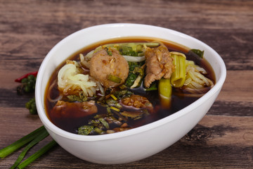 Thai style soup with meat and mushrooms