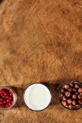 Yogurt with nuts on a wooden light background. View from above. Natural yogurt.
