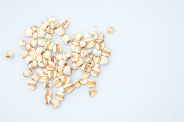 millet in a wooden bowl isolated on white