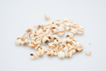 millet in a wooden bowl isolated on white