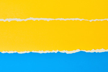 Torn ripped paper edge with a copy space, color blue and yellow background
