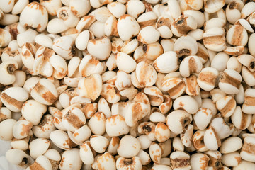 millet in a wooden bowl isolated on white